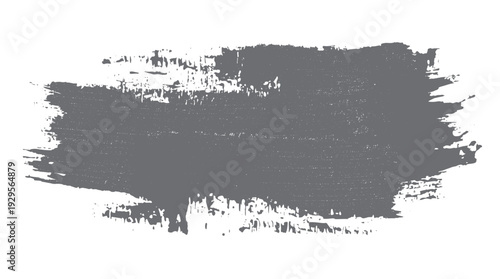 Gray textured brush stroke with rough edges and scattered dots on a white background