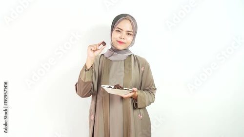 Muslim Woman with Happy Expression and Offering Dates Gesture Isolated on White Background in Studio. 4k Video