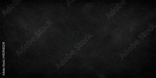 A dark and textured black chalkboard background with a grunge vintage surface and rough grey stone pattern features blank space and a frame for an old blackboard design