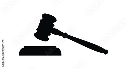 A stark black silhouette of a gavel resting on a sound block representing justice and legal authority silhouette