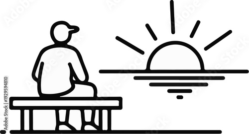 A person sits on a bench watching the sun rise over the water