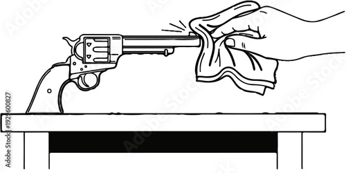 Hand polishing a vintage revolver on a table