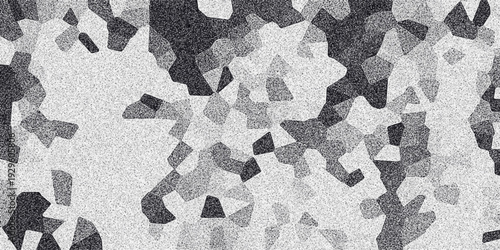 Abstract mosaic pattern with irregular polygonal shapes in grayscale shades of black and white with a subtle granular texture