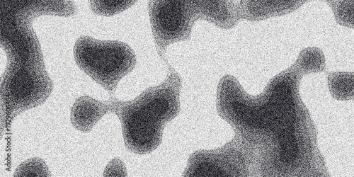 Organic monochrome abstract background with irregular dark blotches and speckled grainy texture creating a fluid and naturalistic visual effect