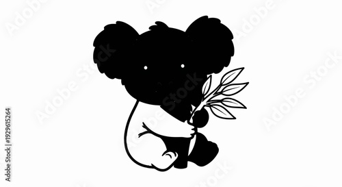 Cute black koala bear sitting and holding eucalyptus leaves in its paws