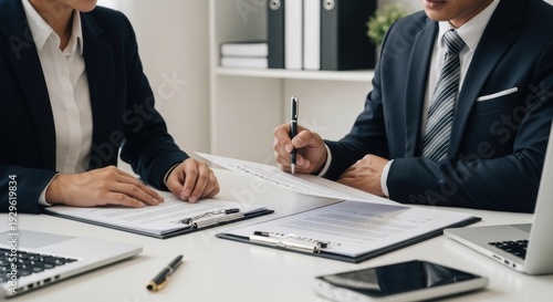 Professionals reviewing documents in a business meeting setting