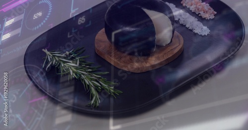 Showing black oval platter on table holding glossy dome on coaster, rosemary white or pink salts HUD