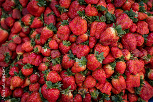 Top view of fresh ripe strawberries filling the frame. Red organic strawberries background texture.