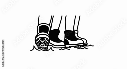 Two pairs of black boots stand in water, one pair close up