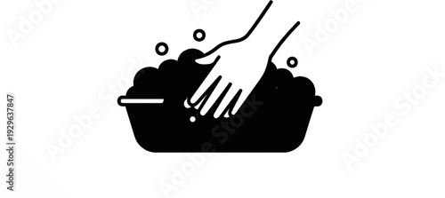 Hand washing in soapy water with bubbles in a basin