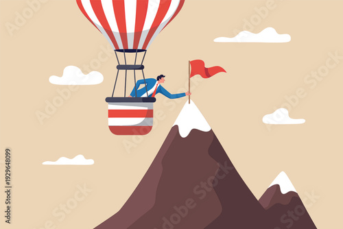 Businessman in a hot air balloon planting a red flag on a mountain peak to reach his goal.