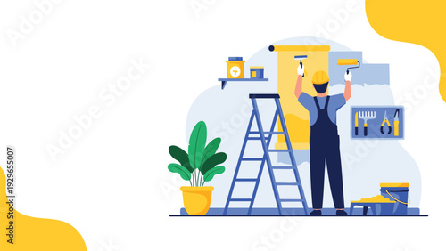 Professional male painter wearing a yellow hard hat and blue overalls painting a room wall with a large roller brush.