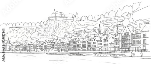 A charming European riverside town with a castle overlooking charming old buildings