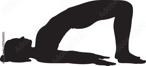 Woman in bridge yoga pose on mat in black silhouette
