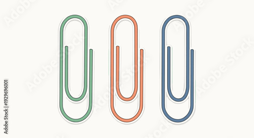 Set of three colorful large paper clips in green orange and blue tones isolated on a neutral white background.
