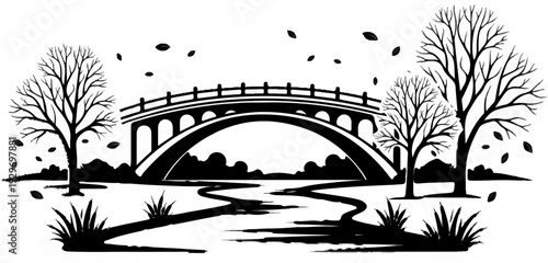 Silhouette of an arched bridge with trees and falling leaves over a winding stream