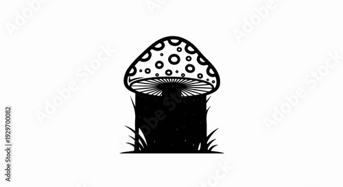 Black and white drawing of a polka-dotted mushroom with gills, on grass