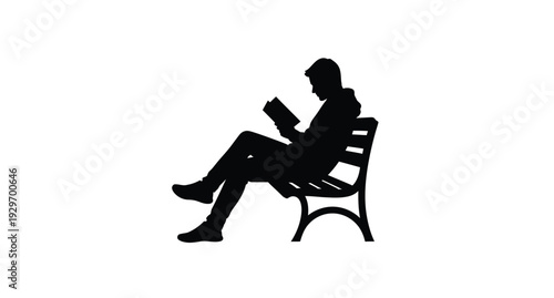 A person reading a book while seated on a park bench silhouette