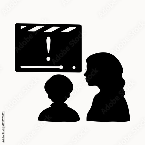 Silhouettes of woman and child watching movie on screen