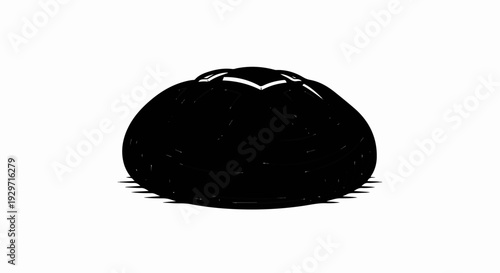 A dark, domed object with subtle indentations casting a striped shadow