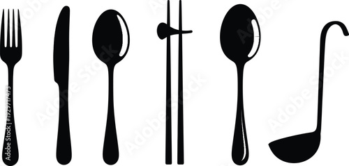 Assortment of black cutlery and utensils arranged neatly on white background