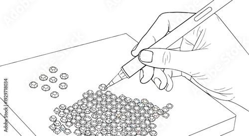 Close-up of a hand using a tool to pick up a small faceted gem for placement