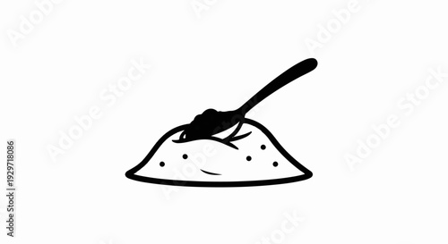 A spoon scoops a portion from a pile of granulated powder