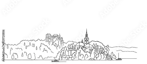Scenic view of a lakeside town with a castle on a hill and a church