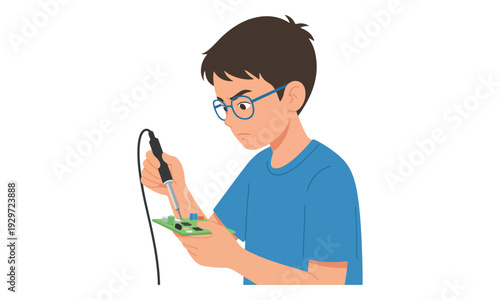 Young boy soldering circuit board, working on electronics project