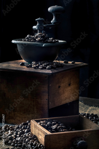 Vintage Coffee Grinder with Dark Roasted Beans. Dark and rustic moody still life