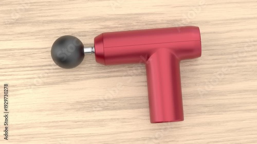 Wallpaper Mural Red massage gun on wooden table Torontodigital.ca