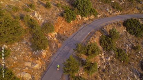 Adult Woman with Extra Weight Jogging in Countryside Landscape During Sunset to Improve Health, drone view