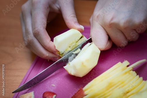 Wallpaper Mural Slicing a peeled apple with a vintage knife on a pink plastic board for apple pie. Home baking preparation. Torontodigital.ca
