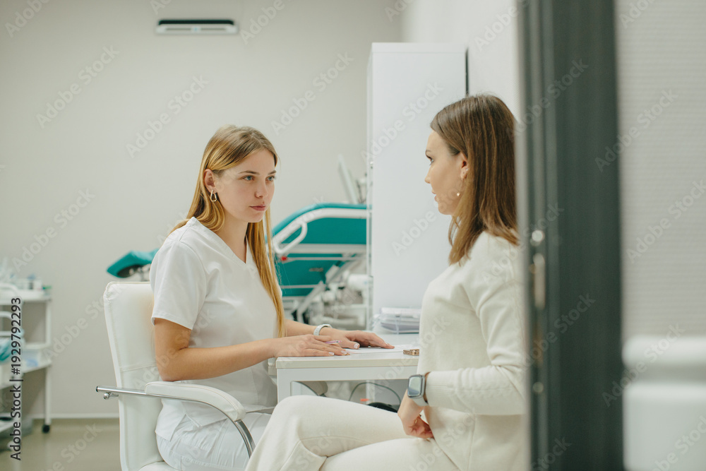 Fototapeta premium Doctor consulting patient during healthcare discussion in clinic