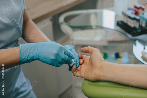 Tableau sur toile Medical professional performing finger stick blood test