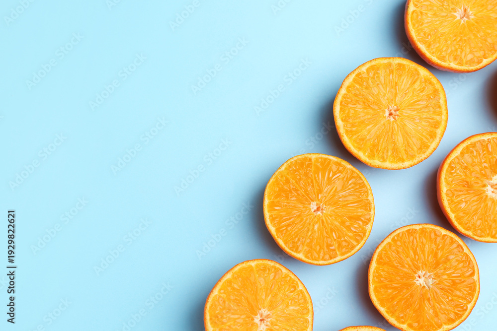 Fototapeta premium Fresh juicy tangerines on light blue background, flat lay. Space for text