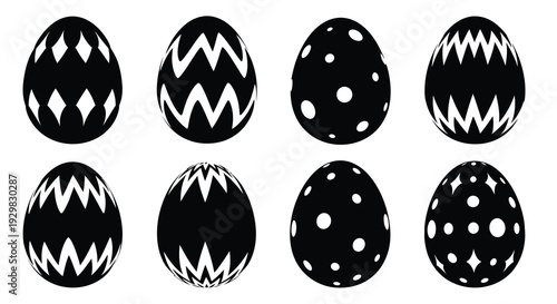 A collection of eight black and white decorated eggs displayed in a grid formation showcasing unique patterns silhouette
