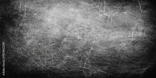 A dark and black grunge background with copy space featuring a textured concrete wall surface with an aged vintage stone pattern and a dirty rough gray metal backdrop