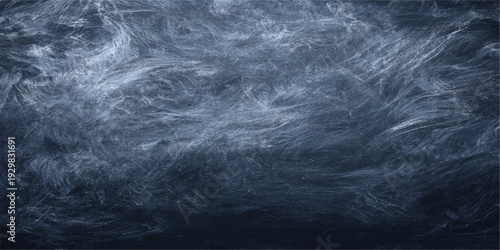 An abstract storm of dark blue smoke swirls against a black and white chalk board texture creating a moody motion pattern of clouds and fog