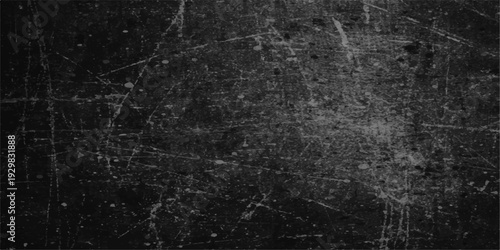 A dark textured pattern of a spider web in the rain over an old grunge black stone surface with aged scratched marble details and a rough gray concrete wallpaper material