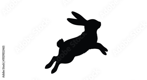 A dynamic black silhouette of a leaping rabbit showcases its form and motion creating a striking visual silhouette