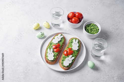 Pesto sauce mozzarella cheese in the form of rabbit rye sandwich in a plate for Easter holidays