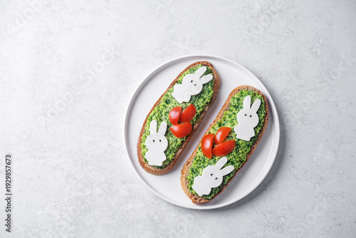 Pesto sauce mozzarella cheese in the form of rabbit rye sandwich in a plate for Easter holidays