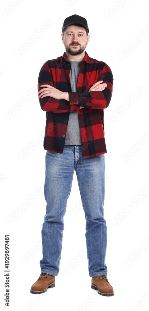 Naklejka premium Long-haul truck driver in baseball cap and red checkered shirt with crossed arms against white background
