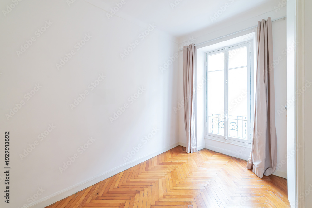 Fototapeta premium Empty white room with herringbone wooden floor and tall window.