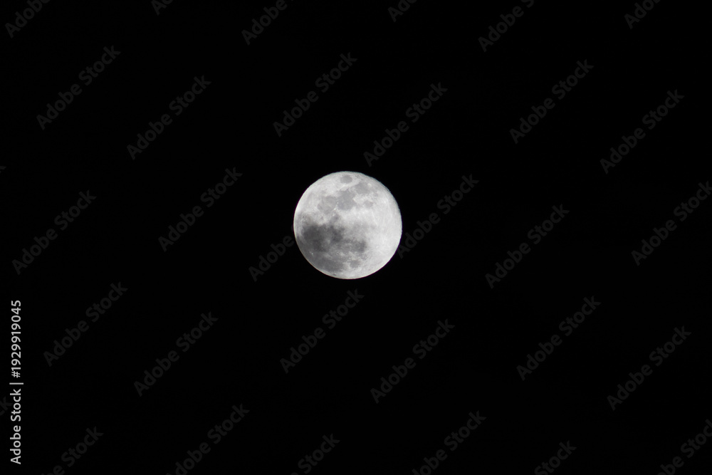 Fototapeta premium Moon among dark clouds, full moon with dramatic sky 