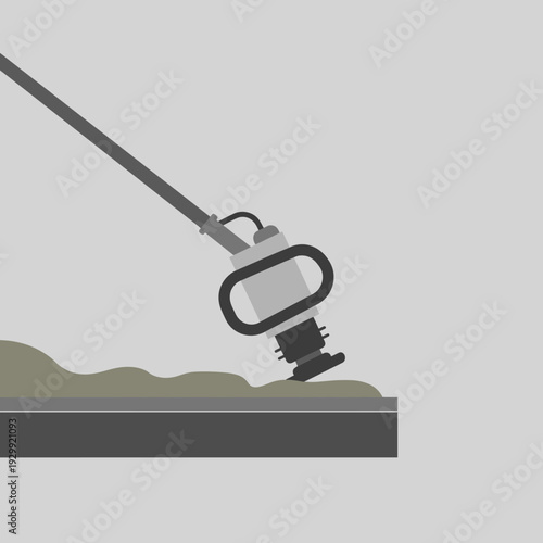 A tamping rammer compacting a layer of soil or gravel on a construction site.
