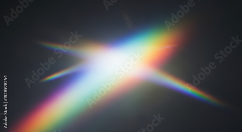 Abstract rainbow prism lens flare with sharp light rays and colorful spectrum on dark background