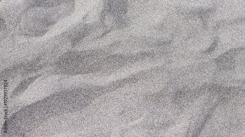 Wallpaper Mural A detailed photo of dark, fine-grain volcanic beach sand, showing natural textures and subtle dune-like ripples. Torontodigital.ca