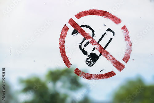 Red Stenciled No Smoking Sign Painted on Glass Window